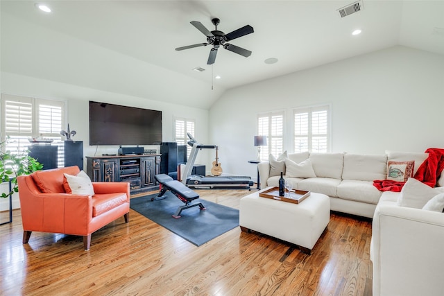 living room with recessed lighting, visible vents, vaulted ceiling, and wood finished floors