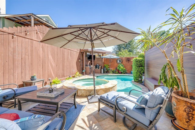 view of patio with a fenced backyard and a pool with connected hot tub