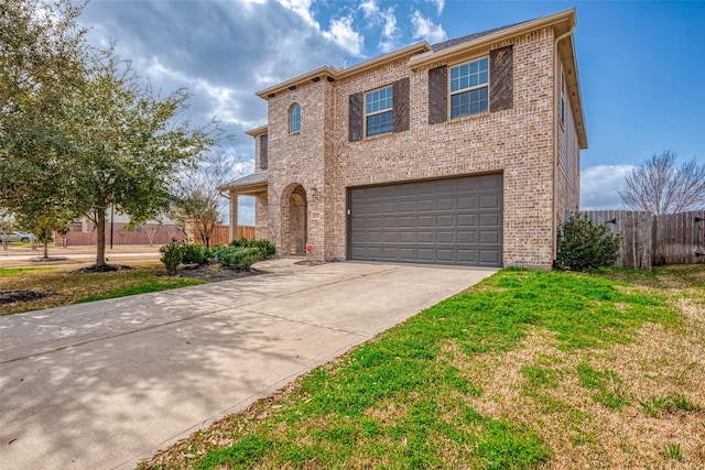 traditional home featuring concrete driveway, brick siding, an attached garage, and fence