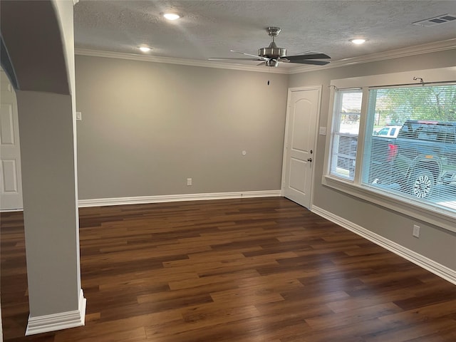 unfurnished room with baseboards, visible vents, ornamental molding, dark wood-style flooring, and a textured ceiling