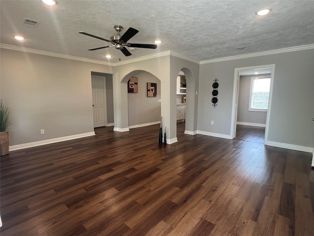 unfurnished living room featuring arched walkways, ceiling fan, dark wood-style flooring, visible vents, and crown molding