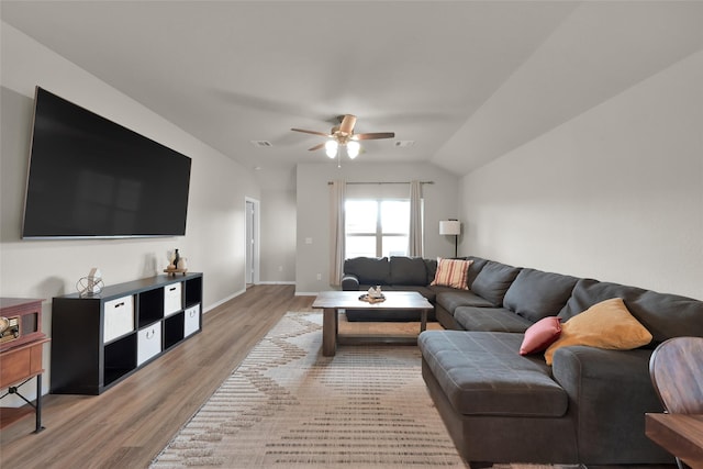 living area with lofted ceiling, ceiling fan, light wood-style flooring, visible vents, and baseboards