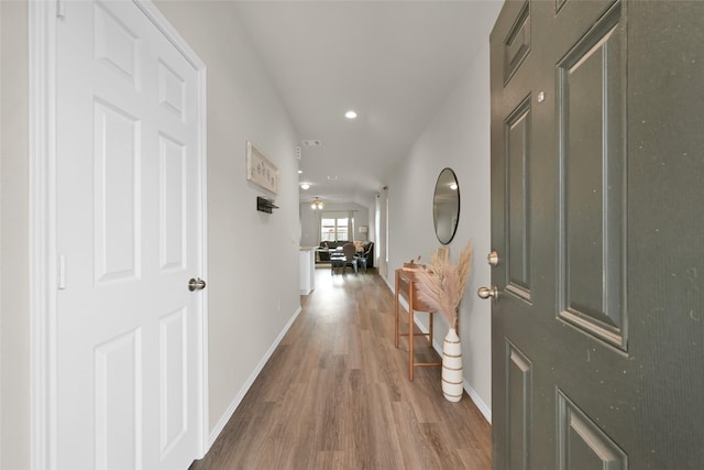 foyer entrance with a ceiling fan, baseboards, wood finished floors, and recessed lighting