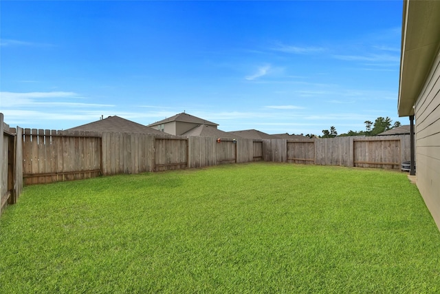 view of yard with a fenced backyard