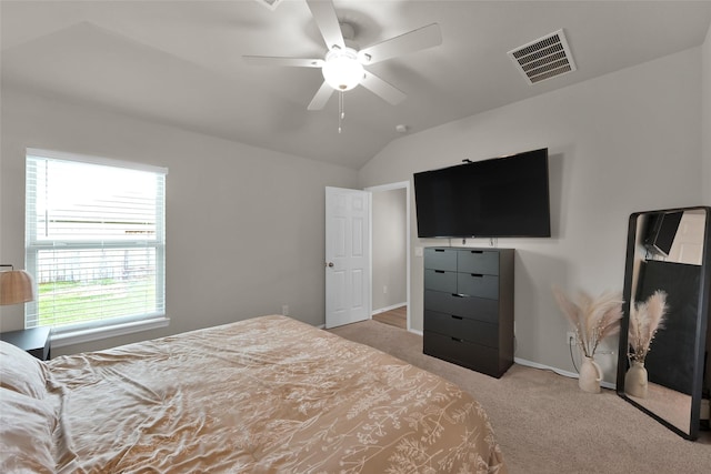 bedroom featuring ceiling fan, light carpet, visible vents, baseboards, and vaulted ceiling