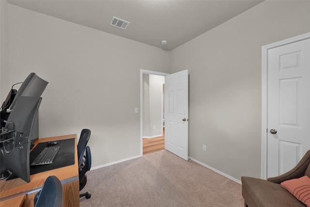 office with carpet floors, visible vents, and baseboards