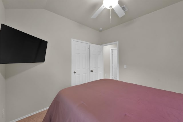 carpeted bedroom with lofted ceiling, ceiling fan, visible vents, and baseboards