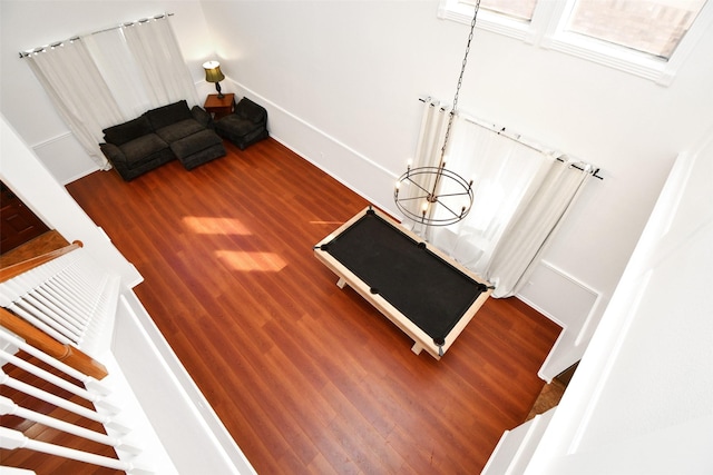 interior space with wood finished floors and a chandelier