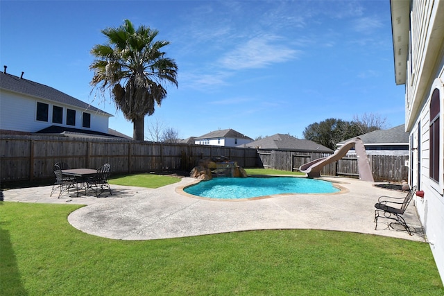 view of swimming pool featuring a fenced in pool, a water slide, a fenced backyard, a patio area, and a lawn