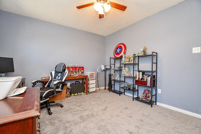 office area with lofted ceiling, carpet flooring, baseboards, and ceiling fan