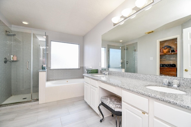 full bathroom featuring visible vents, a stall shower, a sink, double vanity, and a bath