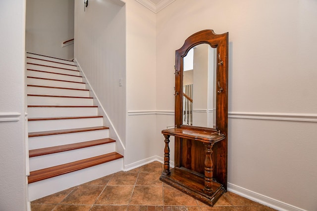 staircase featuring crown molding and baseboards