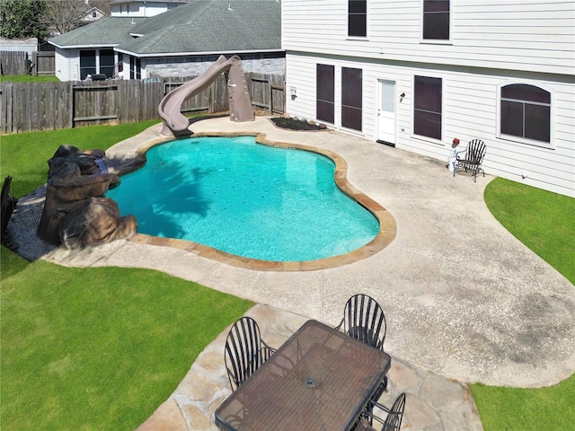 view of swimming pool with a fenced in pool, a water slide, a fenced backyard, a patio area, and outdoor dining space