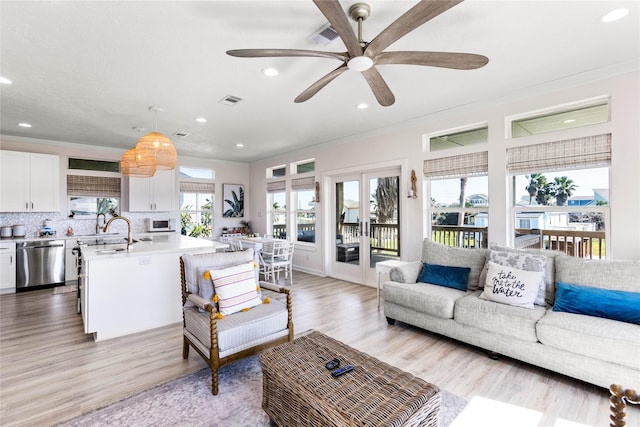 living area featuring light wood-type flooring, french doors, visible vents, and recessed lighting