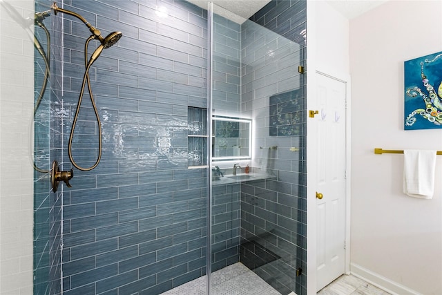 bathroom featuring a shower stall and baseboards