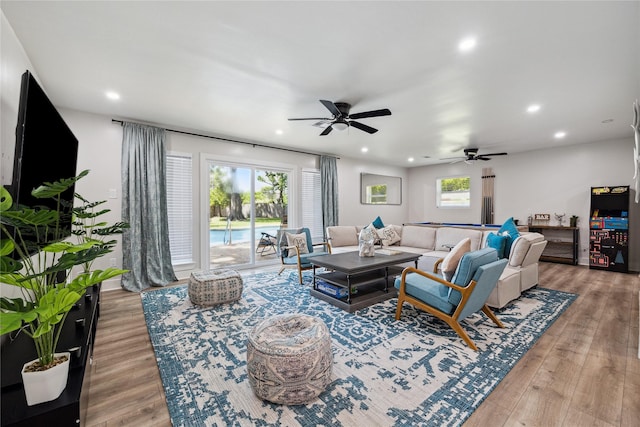 living area with light wood-style flooring and recessed lighting