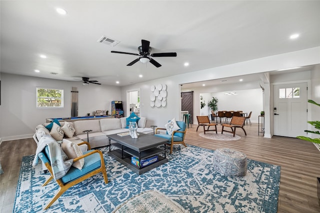 living room with visible vents, wood finished floors, and recessed lighting