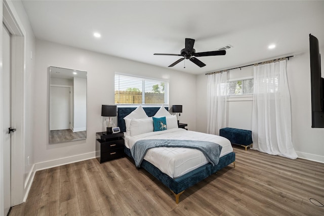 bedroom featuring recessed lighting, visible vents, ceiling fan, wood finished floors, and baseboards