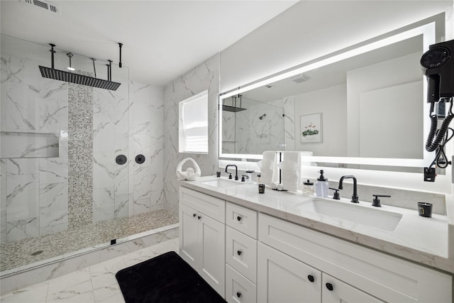 full bath featuring marble finish floor, a marble finish shower, visible vents, and a sink