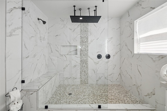 full bath with a marble finish shower