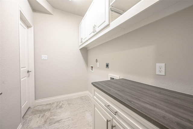 clothes washing area featuring cabinet space, baseboards, hookup for a washing machine, marble finish floor, and electric dryer hookup