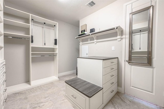 spacious closet featuring marble finish floor and visible vents