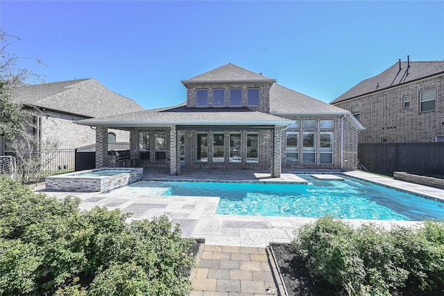 rear view of house featuring a patio area, a fenced backyard, a pool with connected hot tub, and brick siding