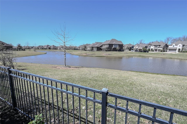 property view of water with a residential view and fence