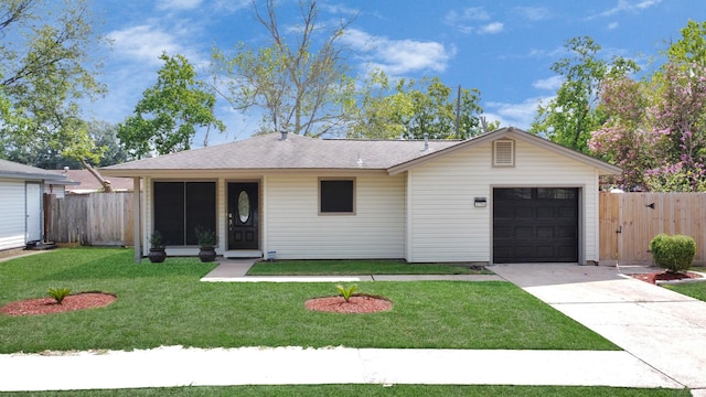 ranch-style home with a garage, concrete driveway, a front yard, and fence