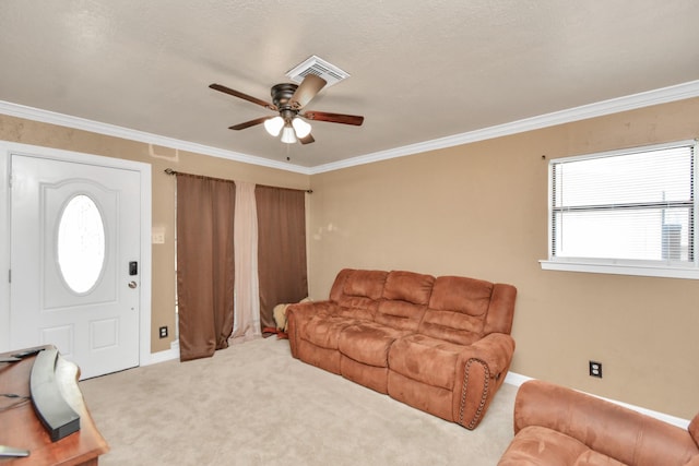 living room featuring ceiling fan, ornamental molding, carpet, and baseboards