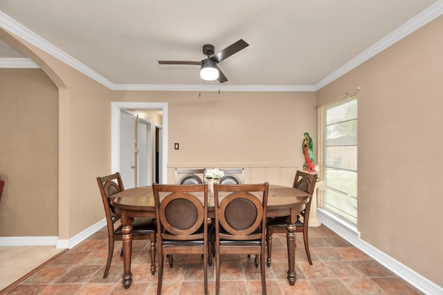 dining area featuring washer / dryer, baseboards, arched walkways, and ornamental molding