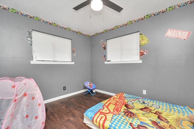 bedroom with a ceiling fan, baseboards, and wood finished floors