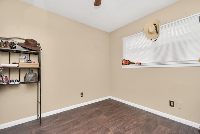 empty room with ceiling fan, wood finished floors, and baseboards