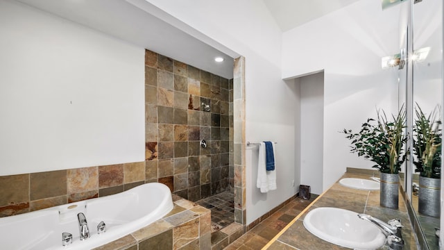 bathroom featuring a sink, tiled shower, a garden tub, and double vanity