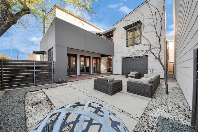 back of house featuring a gate, outdoor lounge area, a patio, and fence