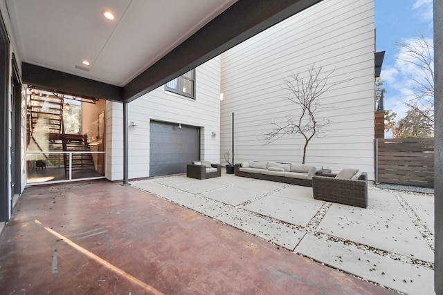 view of patio featuring outdoor lounge area and fence