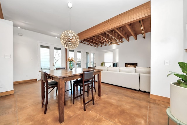 dining area with baseboards, concrete floors, french doors, beamed ceiling, and a chandelier