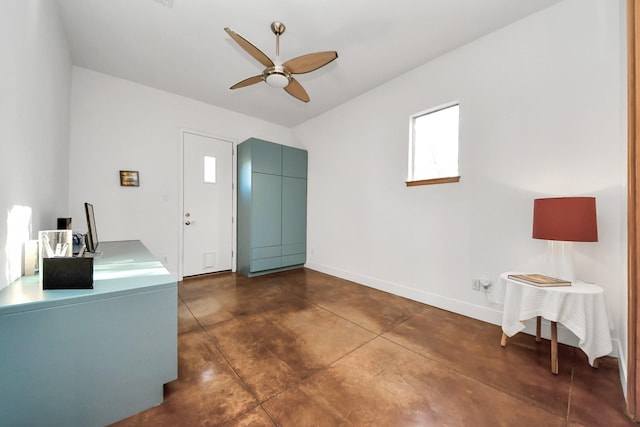 entryway with ceiling fan, concrete floors, and baseboards