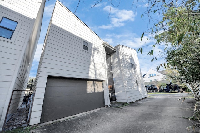 view of home's exterior featuring driveway and a garage