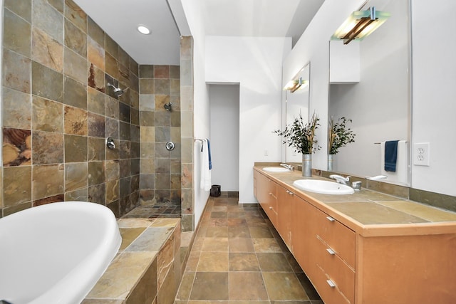 full bath with a bathtub, double vanity, tiled shower, and a sink