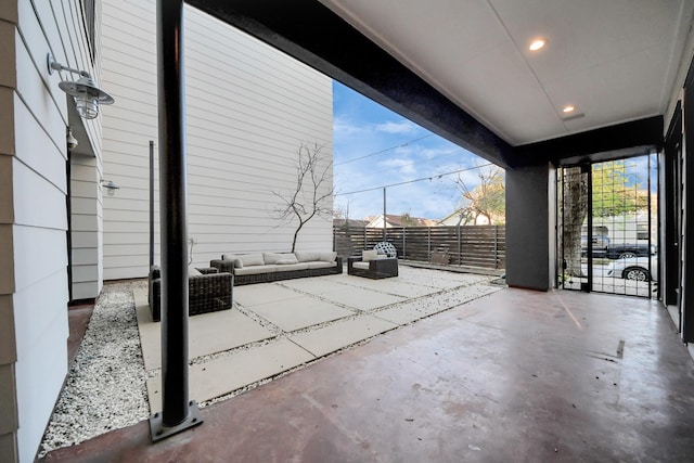 view of patio featuring outdoor lounge area and fence