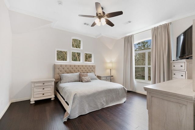 bedroom with dark wood-type flooring, multiple windows, crown molding, and visible vents