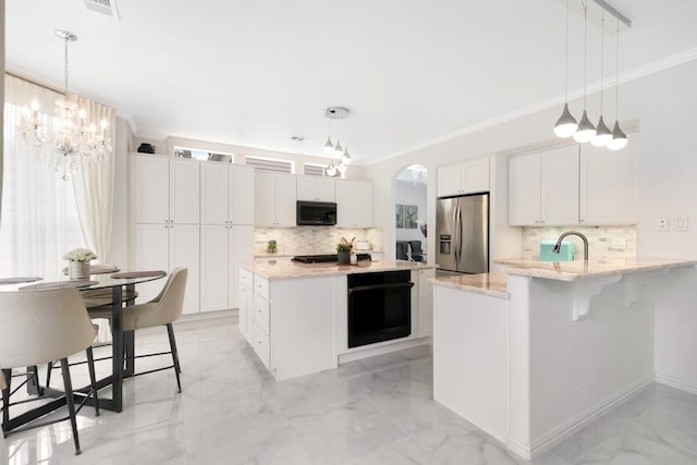 kitchen with a peninsula, arched walkways, black appliances, crown molding, and marble finish floor