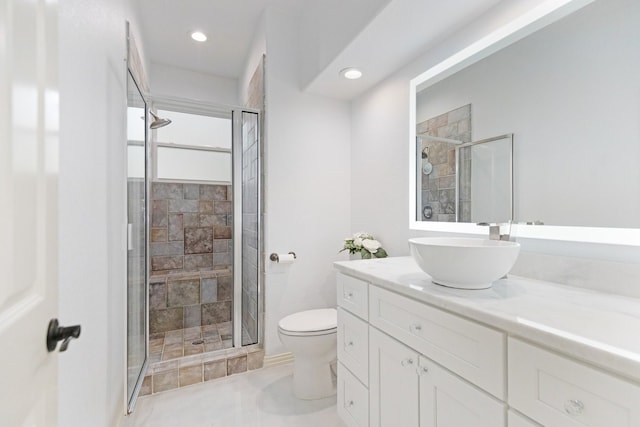 bathroom featuring vanity, a shower stall, toilet, and recessed lighting