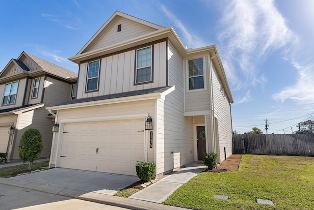 traditional-style home with a garage, fence, concrete driveway, board and batten siding, and a front yard