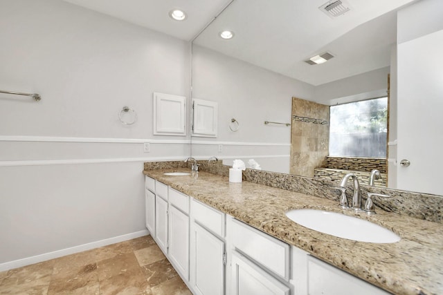 full bathroom with a sink, visible vents, and baseboards