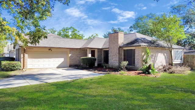 ranch-style home with a garage, concrete driveway, a chimney, a front lawn, and brick siding