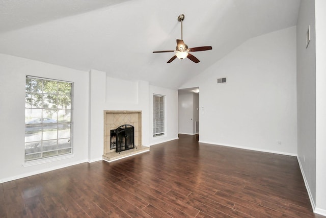 unfurnished living room featuring visible vents, a tiled fireplace, a ceiling fan, wood finished floors, and baseboards