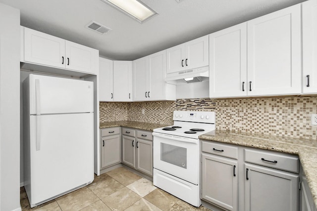 kitchen with under cabinet range hood, white appliances, white cabinetry, visible vents, and decorative backsplash