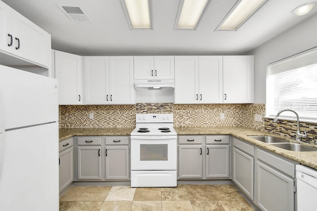 kitchen with visible vents, decorative backsplash, a sink, white appliances, and under cabinet range hood